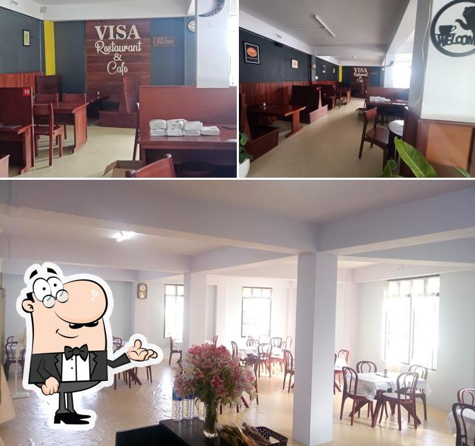 Take a seat at one of the tables at Visa Restaurant And Cafe