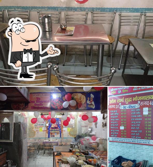 Take a seat at one of the tables at Om Sharma Shud Vaishno Bhojnalya