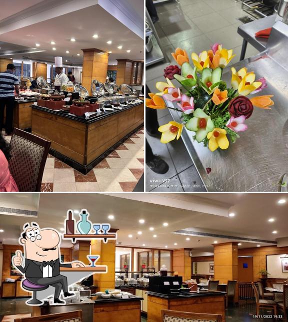 Take a seat at one of the tables at Periyar Multicuisine Restaurant