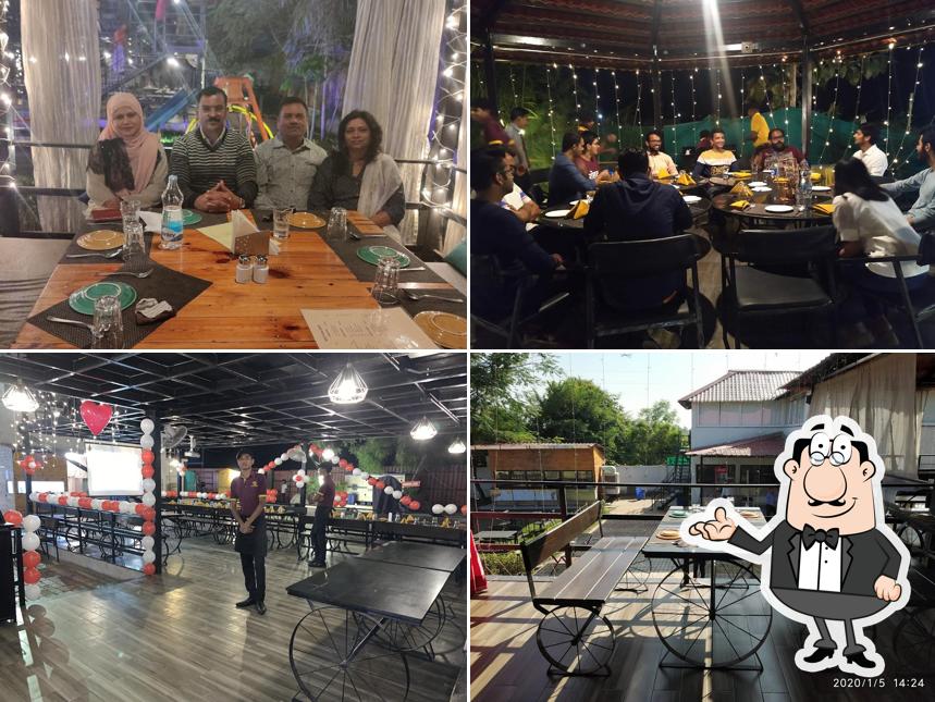 Take a seat at one of the tables at Under The Moon Restaurant Kalmeshwar