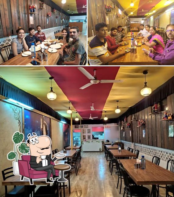 Take a seat at one of the tables at sai sagar food court and restaurant