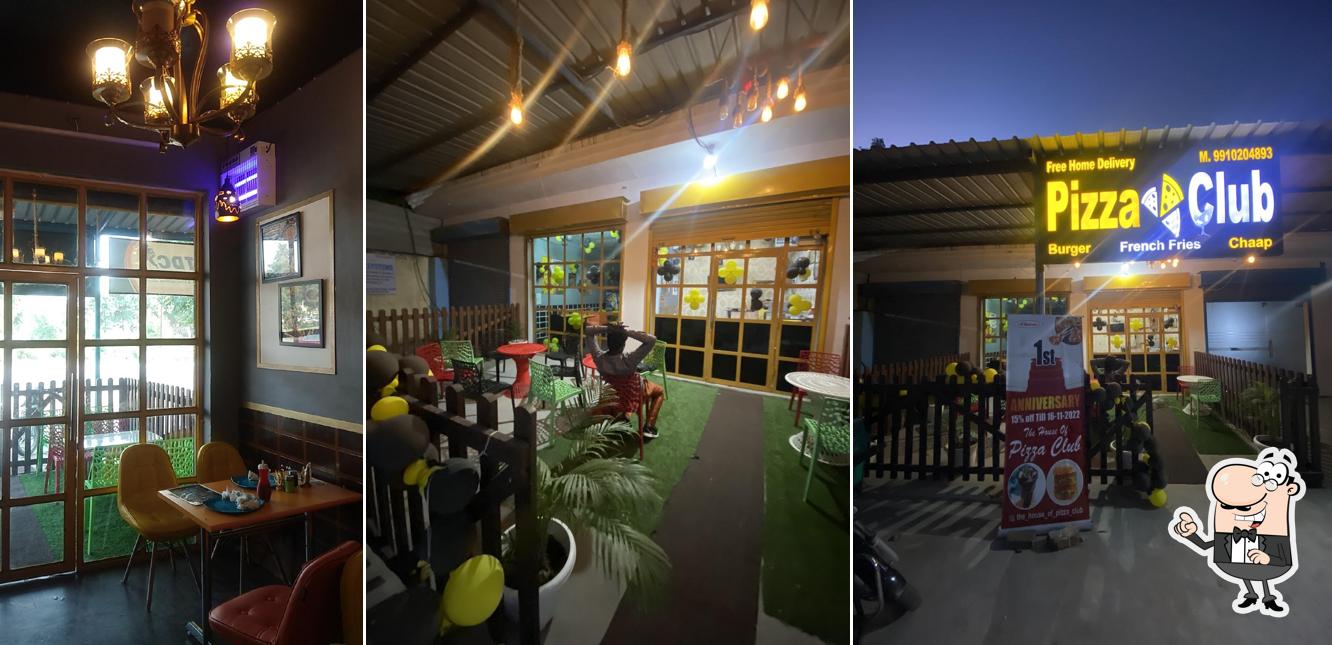 Take a seat at one of the tables at The House Of Pizza Club