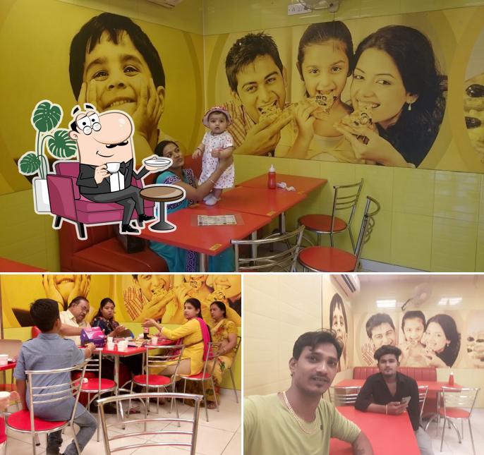Take a seat at one of the tables at Domino's Pizza Sharbatiya lake, Navsari