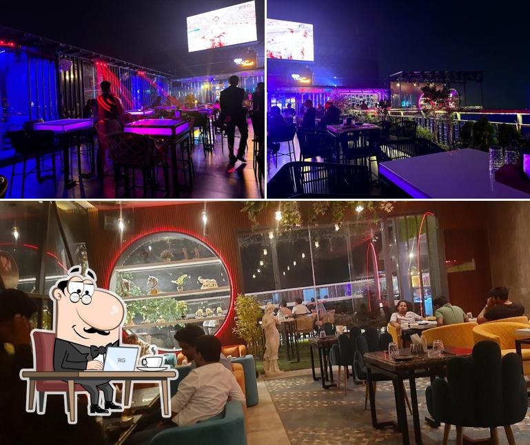 Take a seat at one of the tables at The Trunk Rooftop fine dine Restaurant Mathura Best Cafe in Mathura Best bar in Mathura