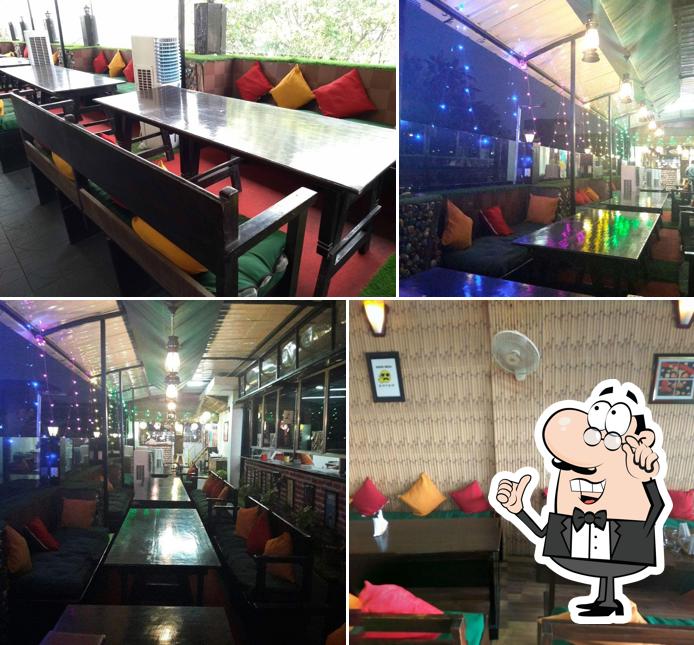 Take a seat at one of the tables at Grand Chathlok Cafe & Multicuisine Restaurant