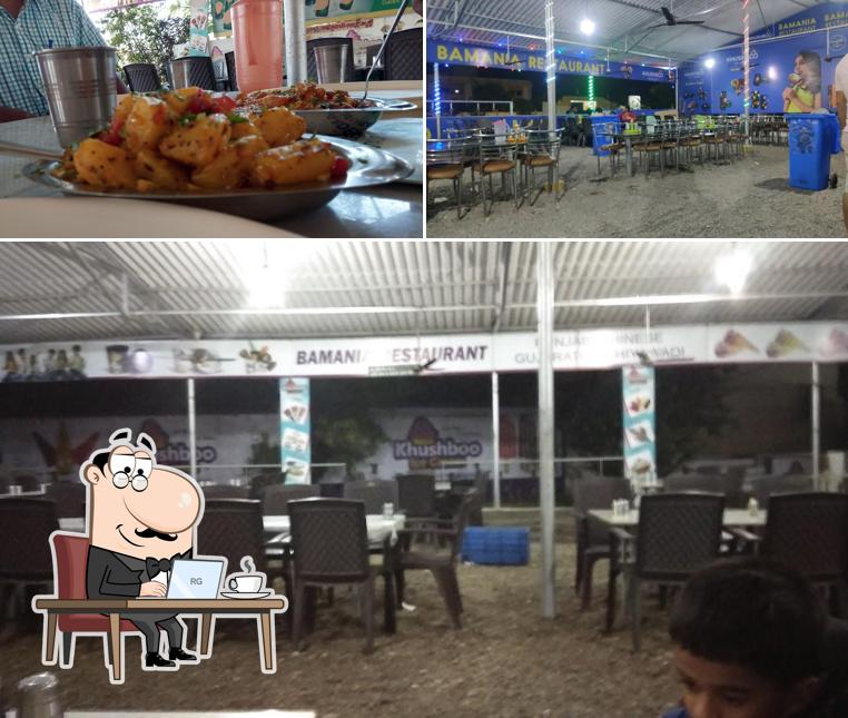 Take a seat at one of the tables at Bamaniya Restaurant