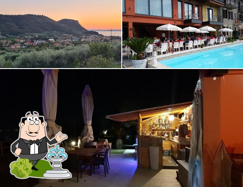 Puoi goderti l'aria fresca da seduto all'esterno di Relais Villa Olivi