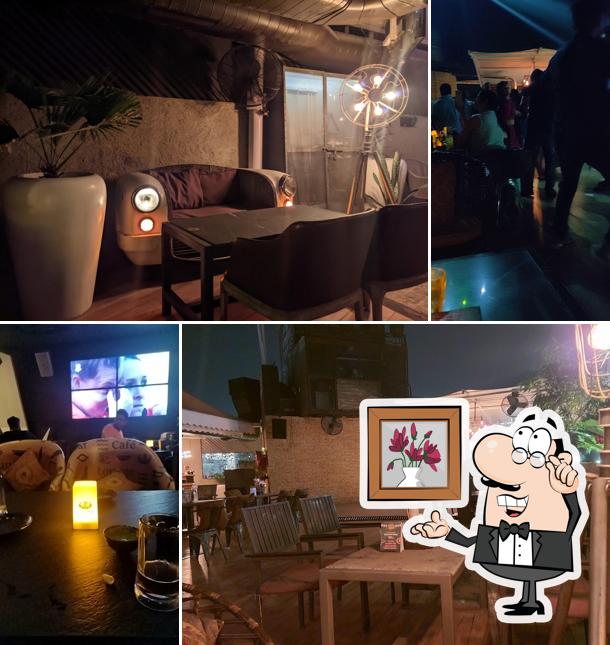 Take a seat at one of the tables at Pyramid Ambala Cafe Lounge Bar Microbrewery Nightclub Sky bar Restaurant