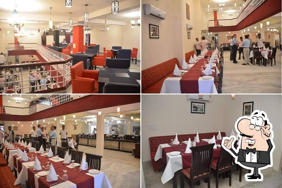 Take a seat at one of the tables at SHREE AANANDAM RESTAURANT