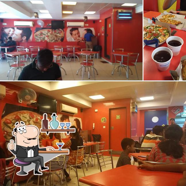Check out the photo depicting interior and dining table at Domino's Pizza Sector 11, Gandhinagar
