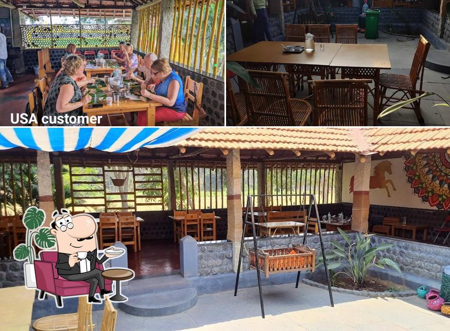 Take a seat at one of the tables at ITIHAKALA RESTAURANT ( Veg Hotel) HALEBIDU / BELUR