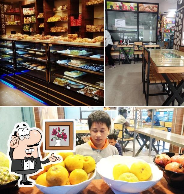 The picture of interior and dining table at Sri Aarya Sweets And Bakery