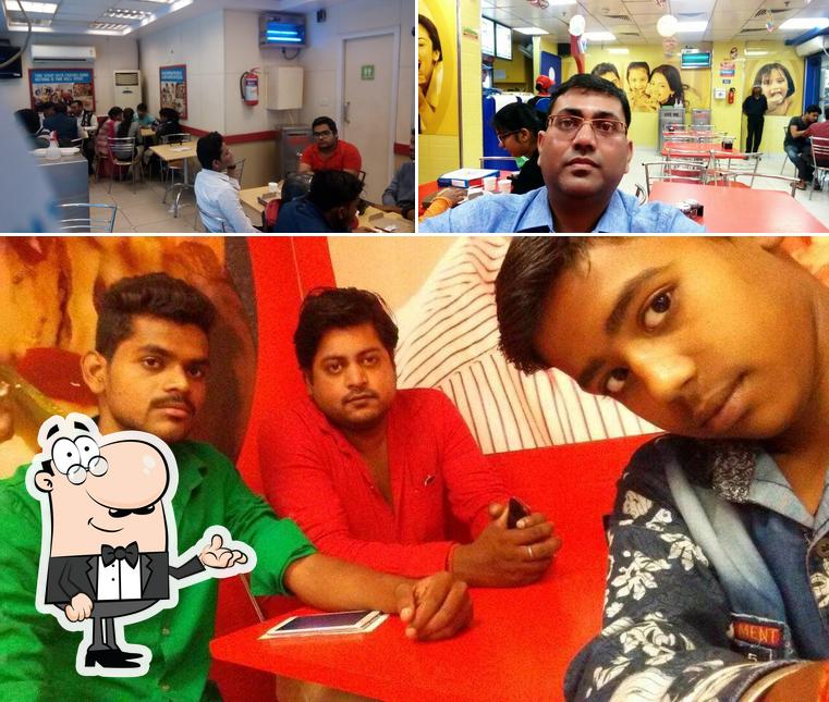 Take a seat at one of the tables at Domino's Pizza Civil Lines, Prayagraj