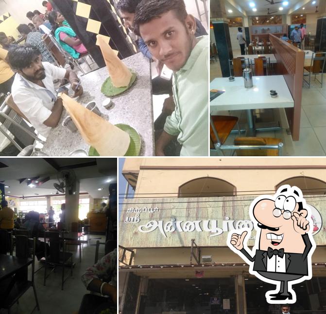 Take a seat at one of the tables at Tirupur Sree Annapoorna Vegetarian Restaurant