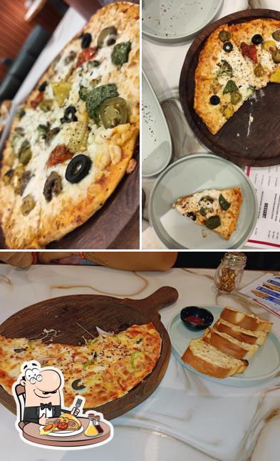 Get pizza at Herbs & Spice ( Cafe & More )