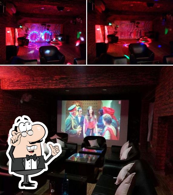 Take a seat at one of the tables at 2 Way Restaurant/Hangout the Gaming Lounge