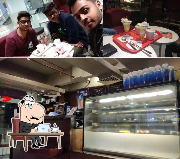 Take a seat at one of the tables at Café Coffee Day