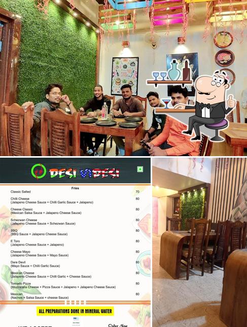 Take a seat at one of the tables at Desi Videsi Restaurant