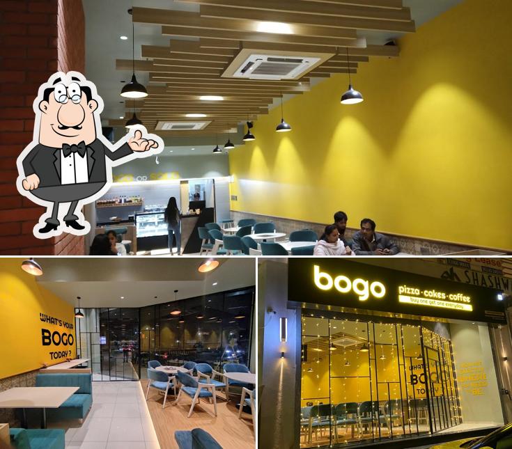 Take a seat at one of the tables at BOGO Pizza-Cakes-Coffee (Buy One Get One Everyday)