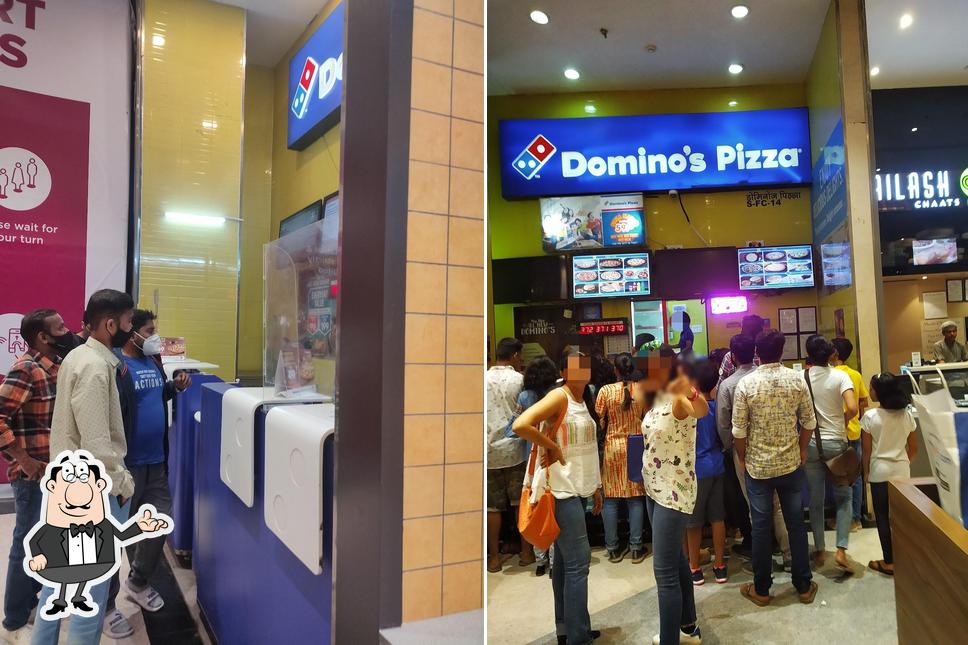 Take a seat at one of the tables at Domino's Pizza Ashok Nagar, Mumbai
