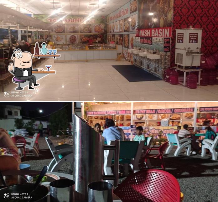 Take a seat at one of the tables at Jay Thakar Dhani Family Restaurant
