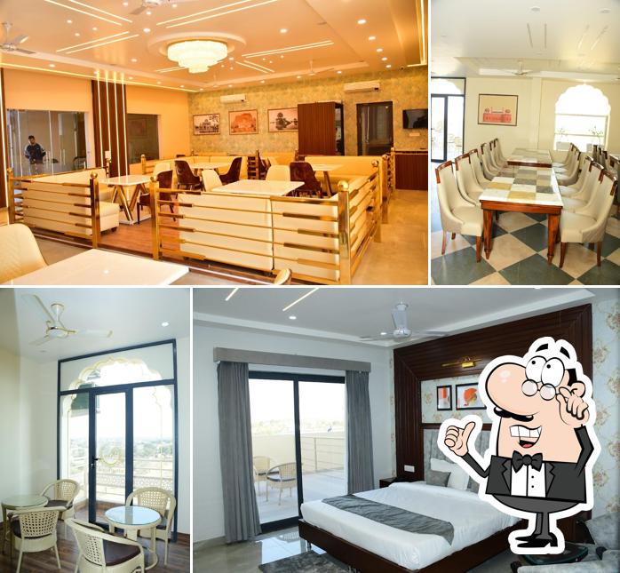 Take a seat at one of the tables at Ratan Mahal Resort - Hotel & Restaurant