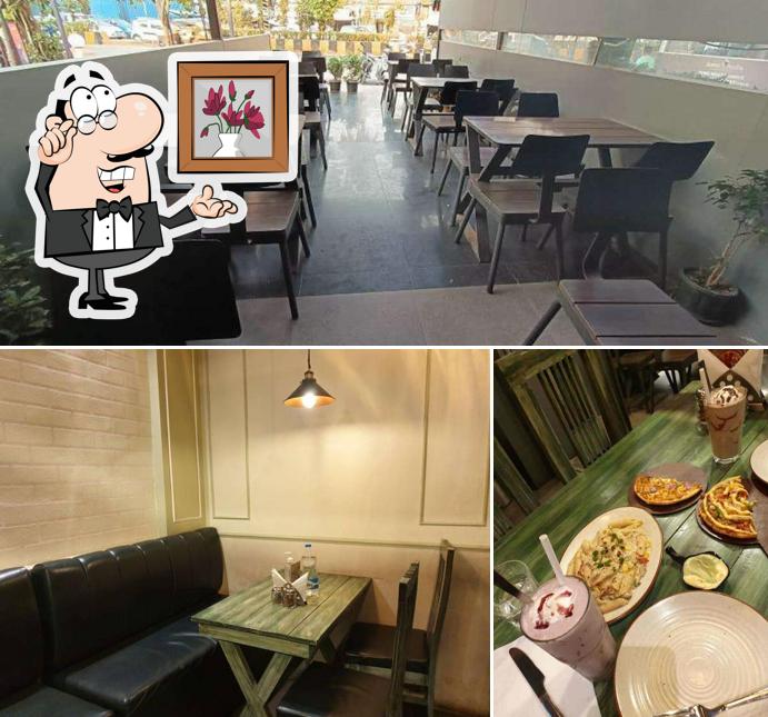 Take a seat at one of the tables at Tossin Pizza Andheri West Best Pizza in Mumbai