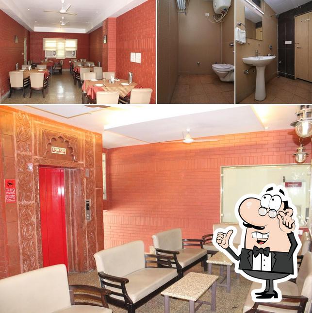 Take a seat at one of the tables at Hotel Malik Residency Kanpur
