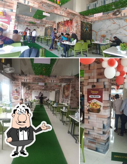 Take a seat at one of the tables at Arambh Biryani Restaurants