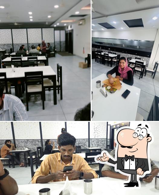 Take a seat at one of the tables at Pazhayidom Ruchi Changaramkulam