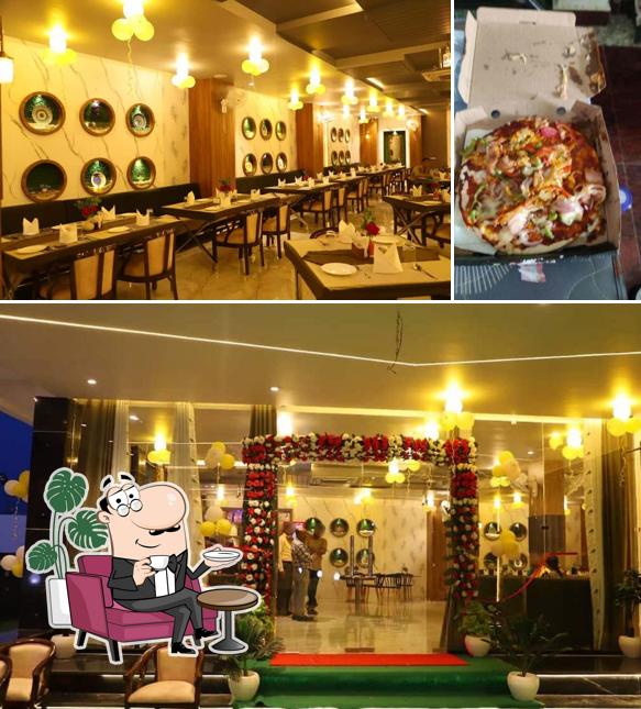 The picture of interior and pizza at Amar Restro Cafe