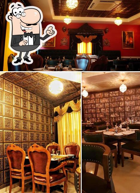 Take a seat at one of the tables at Bakasura Restaurant