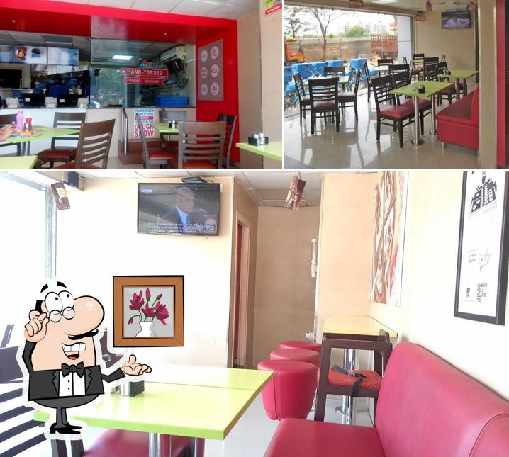Take a seat at one of the tables at Domino's Pizza Quthibullapur, Hyderabad