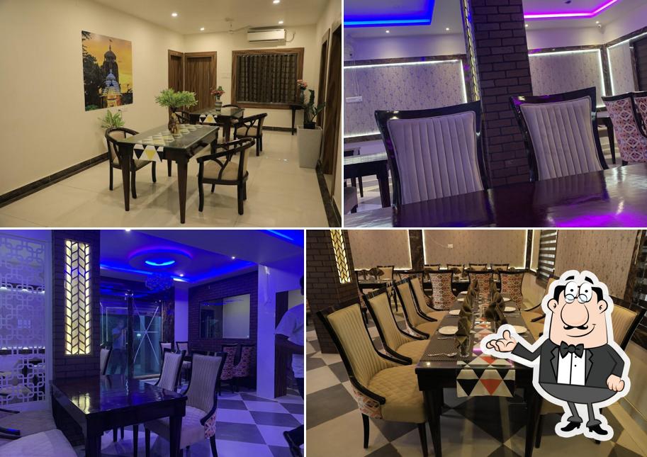 Take a seat at one of the tables at LILY INN (Hotel And Restaurant)