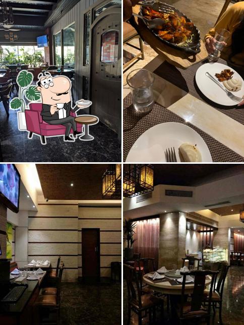 Take a seat at one of the tables at TAP Resto Bar Andheri West