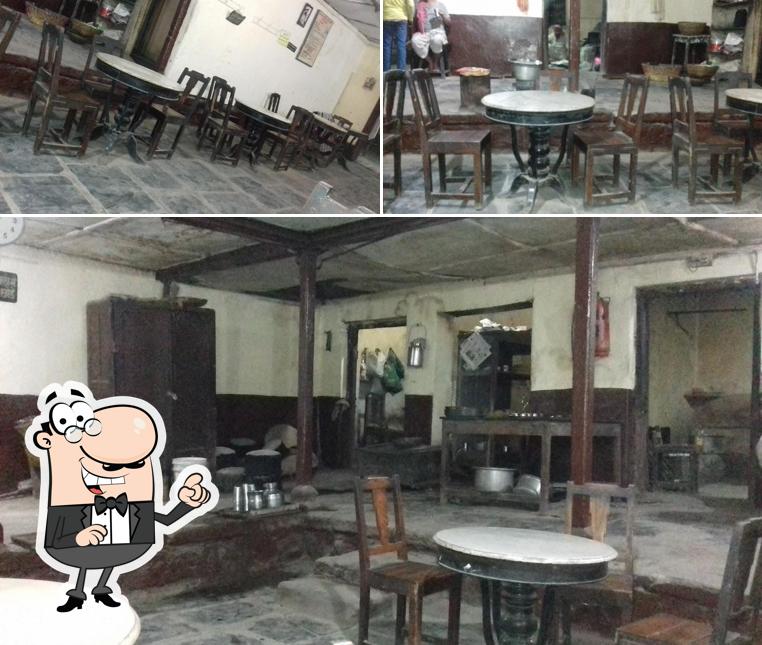 Take a seat at one of the tables at Anandashram Bhojnalaya