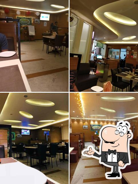 Take a seat at one of the tables at Hyderabad Biryaani House