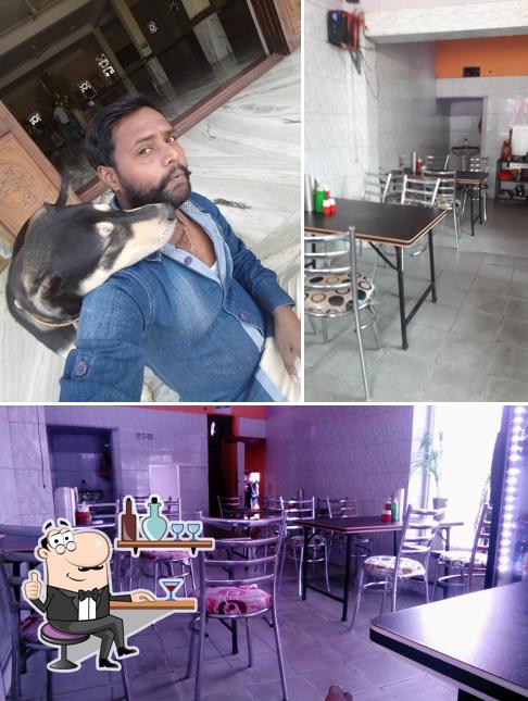 Take a seat at one of the tables at Lucknow Tandoori House And Restaurant