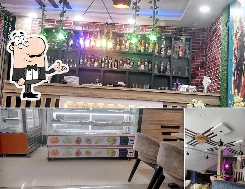 Take a seat at one of the tables at THE KRISHNA SWEETS AND RESTAURANT