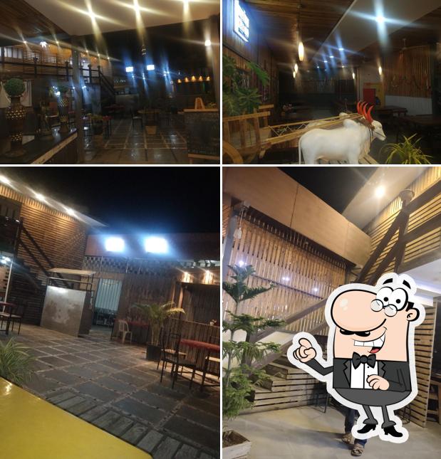 Take a seat at one of the tables at Hotel Madhura- Pure Veg Family Restaurant