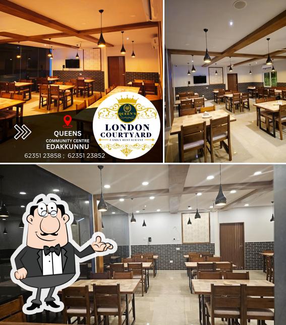 Take a seat at one of the tables at LONDON COURTYARD AC FAMILY RESTAURANT