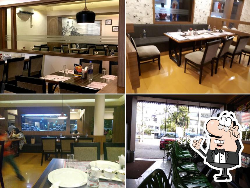 Take a seat at one of the tables at Alibaba & 41 Dishes - Trivandrum Take a seat at one of the tables at Alibaba & 41 Dishes - Trivandrum