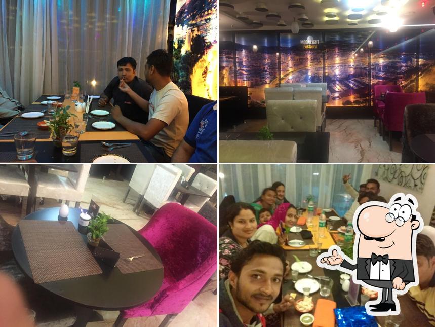 Take a seat at one of the tables at MOON LIGHT RESTAURA