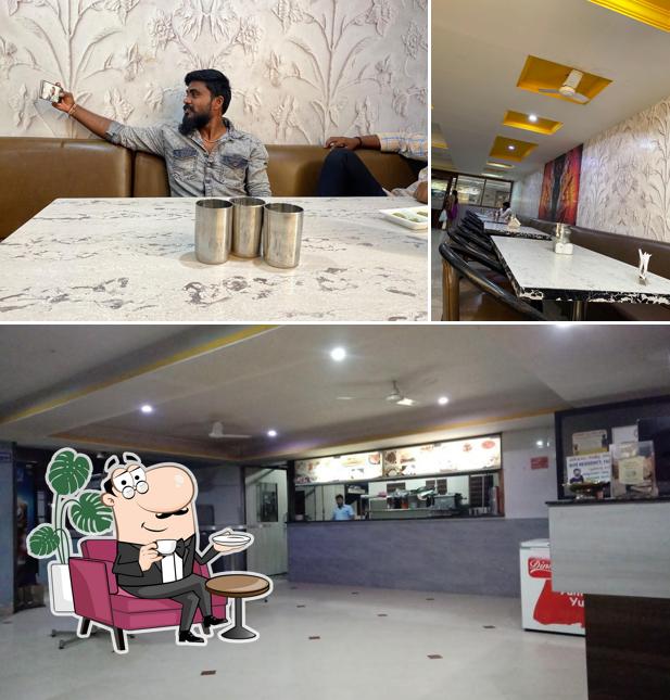 Take a seat at one of the tables at Bhoomi Restaurant