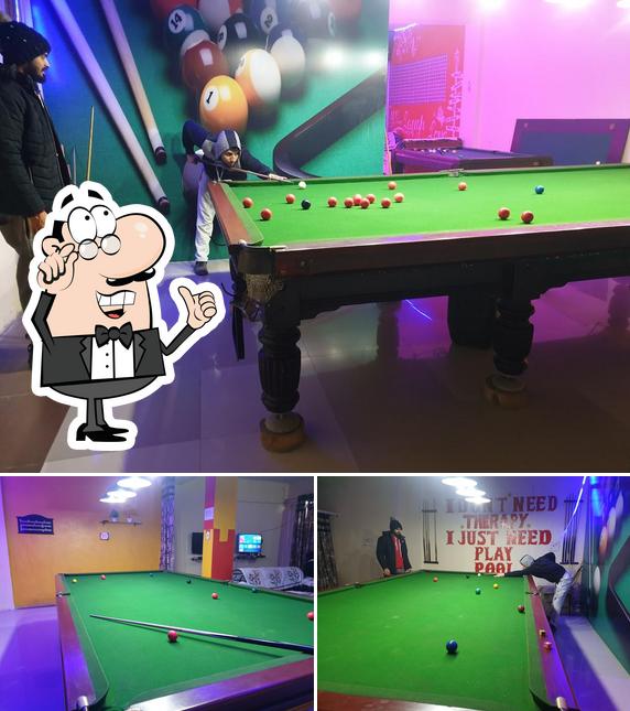 Take a seat at one of the tables at AMM48 Eat & Fun (Fastfood & Gaming)