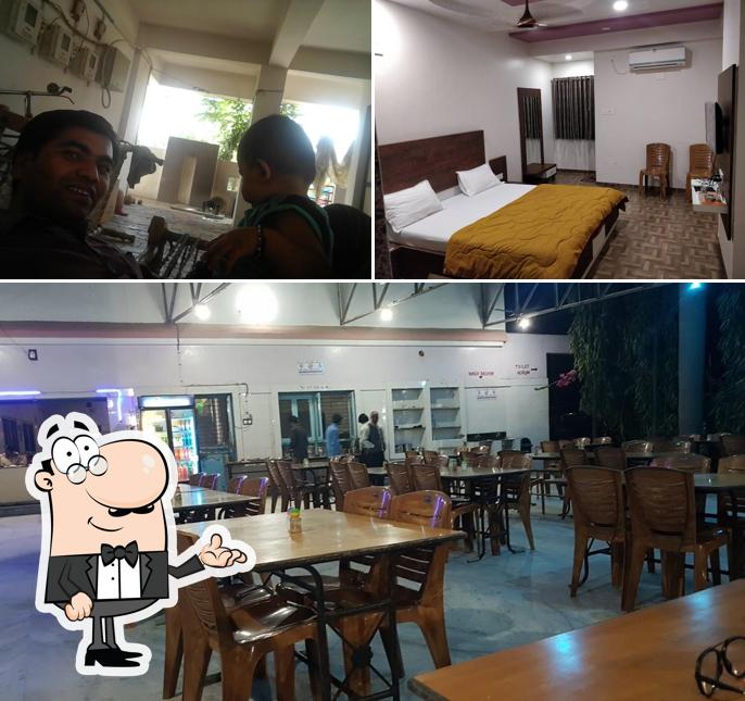 Take a seat at one of the tables at Ramdev Restaurant