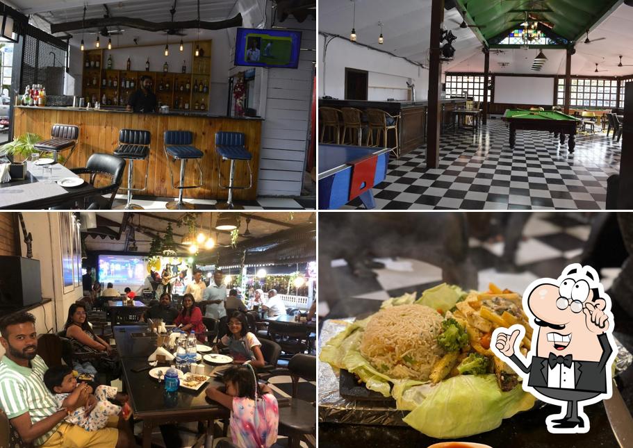 Take a seat at one of the tables at UPTOWN- Multi Cuisine Restaurant - Pub - Sports Bar