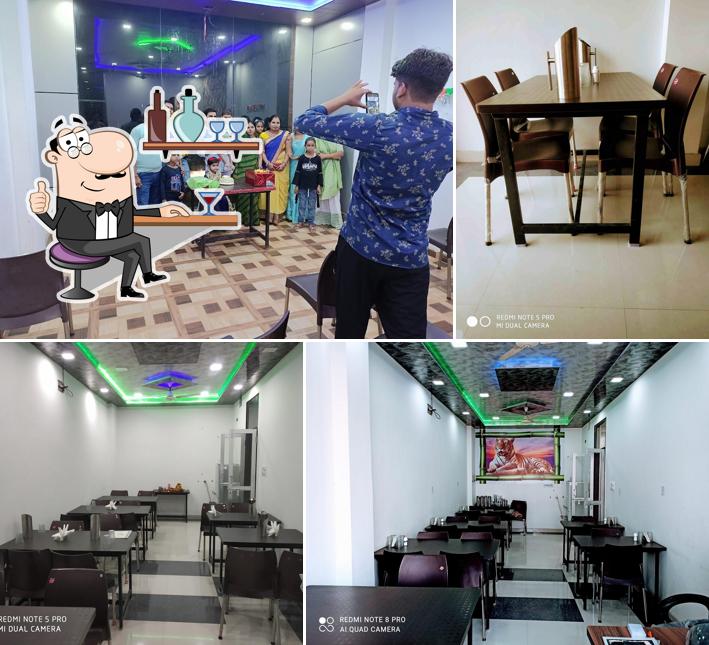 Take a seat at one of the tables at Aryas restaurant & Guest House