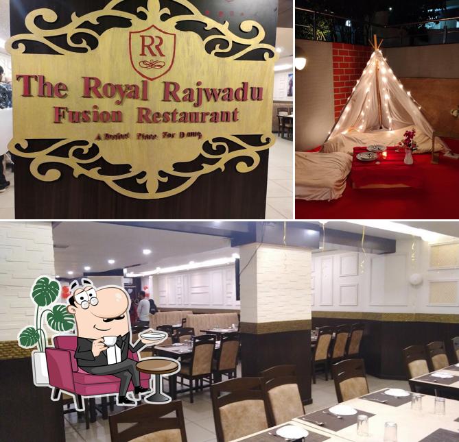 Take a seat at one of the tables at The Royal Rajwadu Restaurant