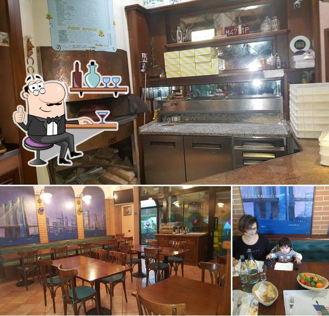 Pizzeria American Pizza Pub si caratterizza per la interni e tavolo da pranzo